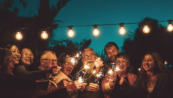 Happy Family Celebrating With Sparkler At Night Party Outdoor - Happy family celebrating with sparklers at night party outdoors