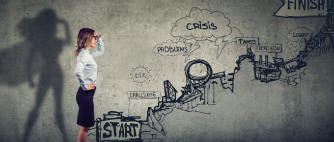 Business career challenges concept. Businesswoman imagining to be a super hero looking aspired making career plans